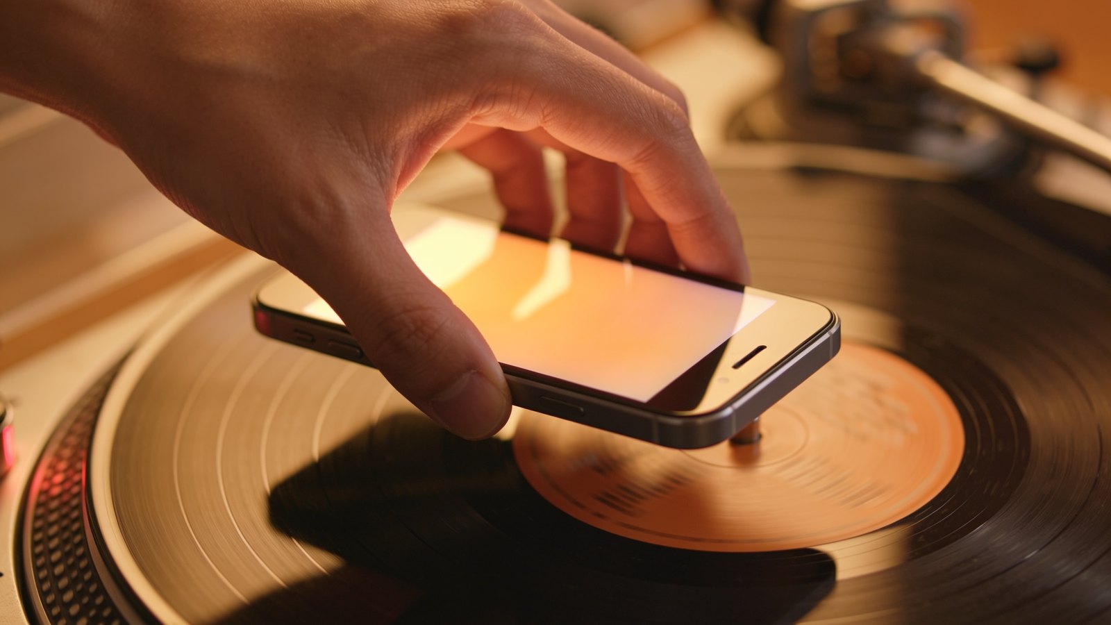 Smartphone camera held over a vinyl record label to identify the exact pressing